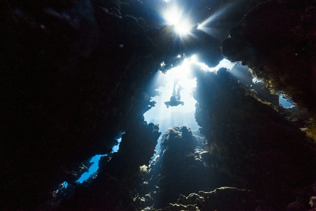 the sun shines through the water in a cave