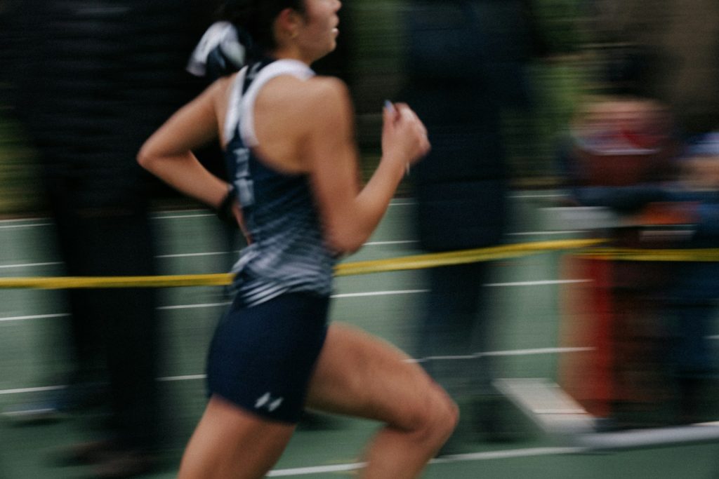 A female runner competes on a track.