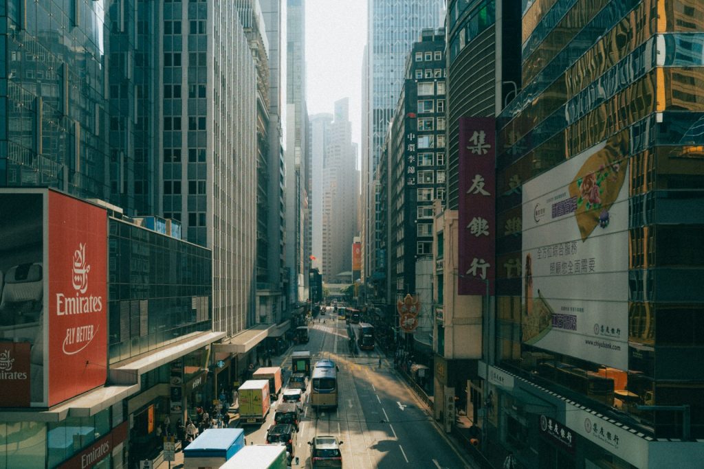 Busy city street with tall buildings and traffic.